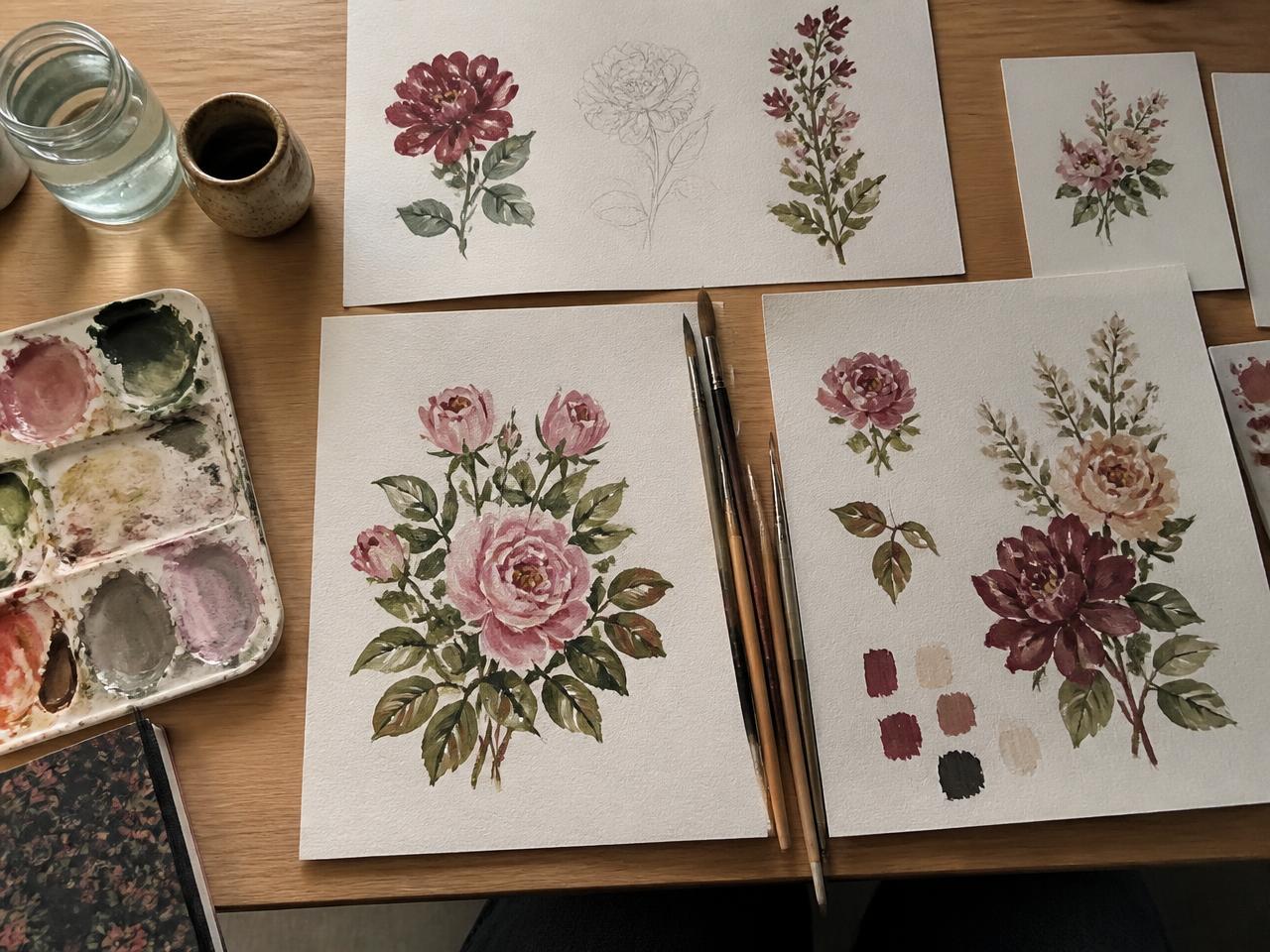 Hand-painted gouache floral studies on watercolour paper with brushes and a paint palette