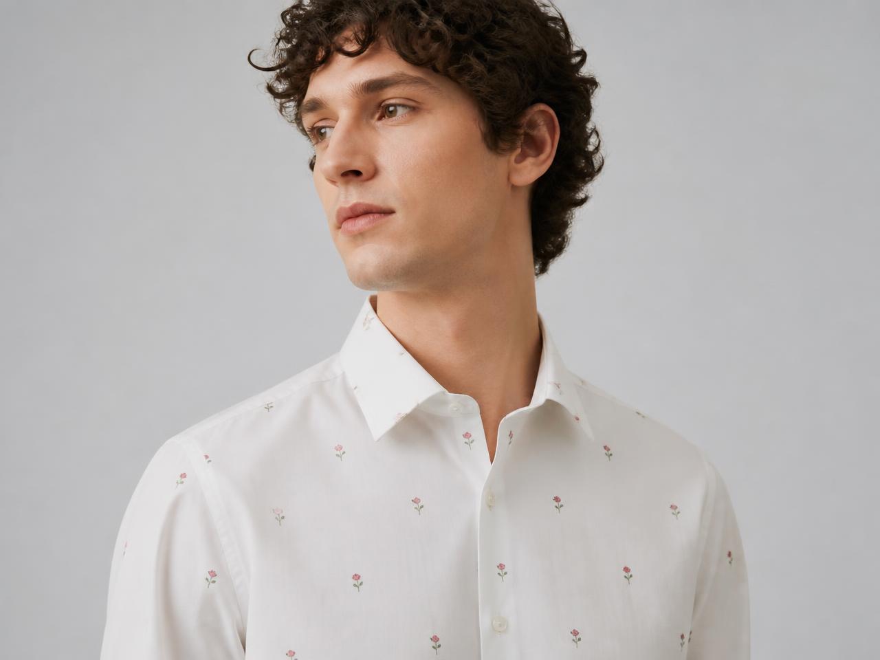 Man wearing a minimal floral print shirt with tiny sparse flowers on off-white cotton