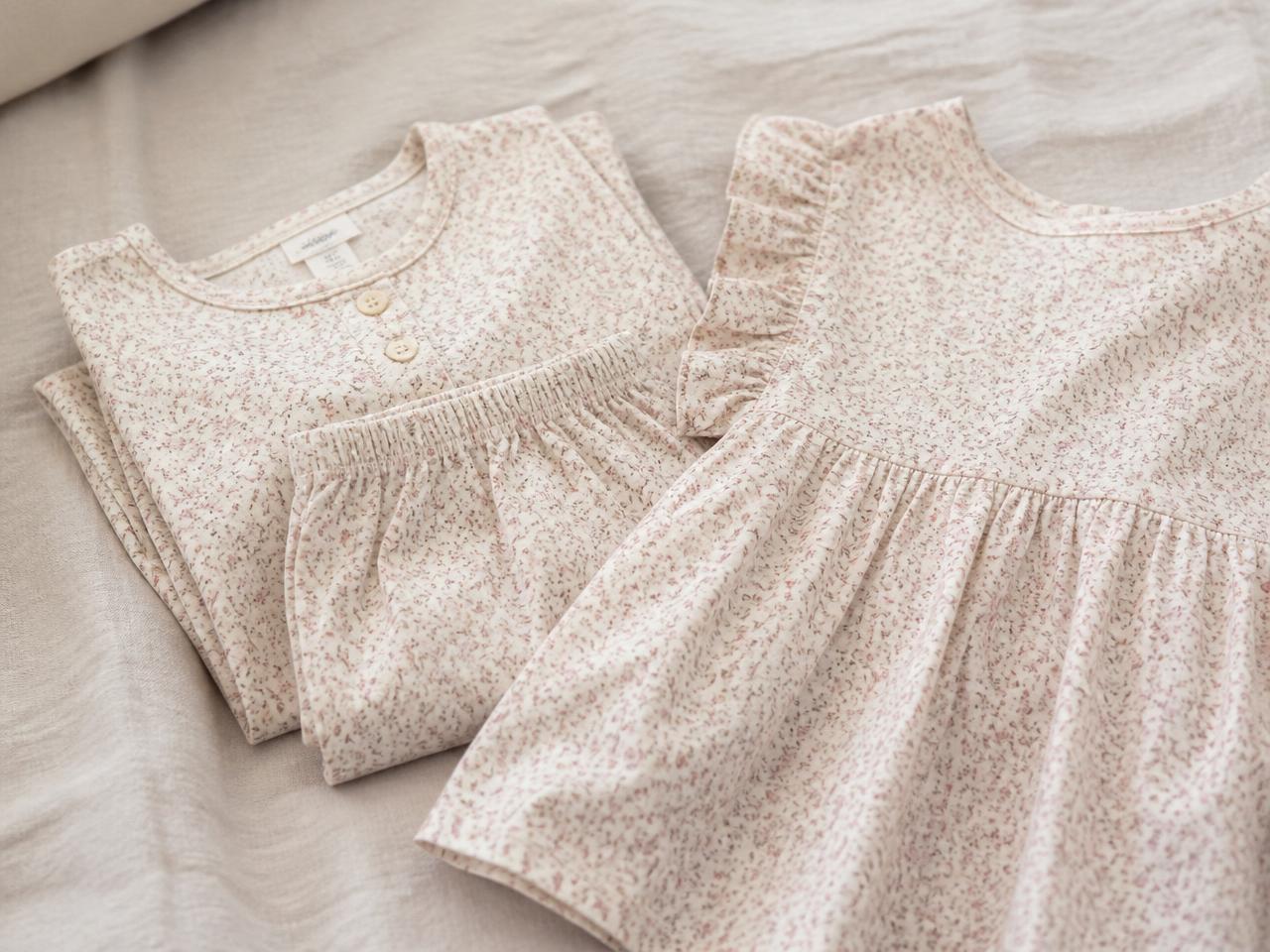 Folded cotton loungewear and a child's dress in a tiny ditsy floral repeat print